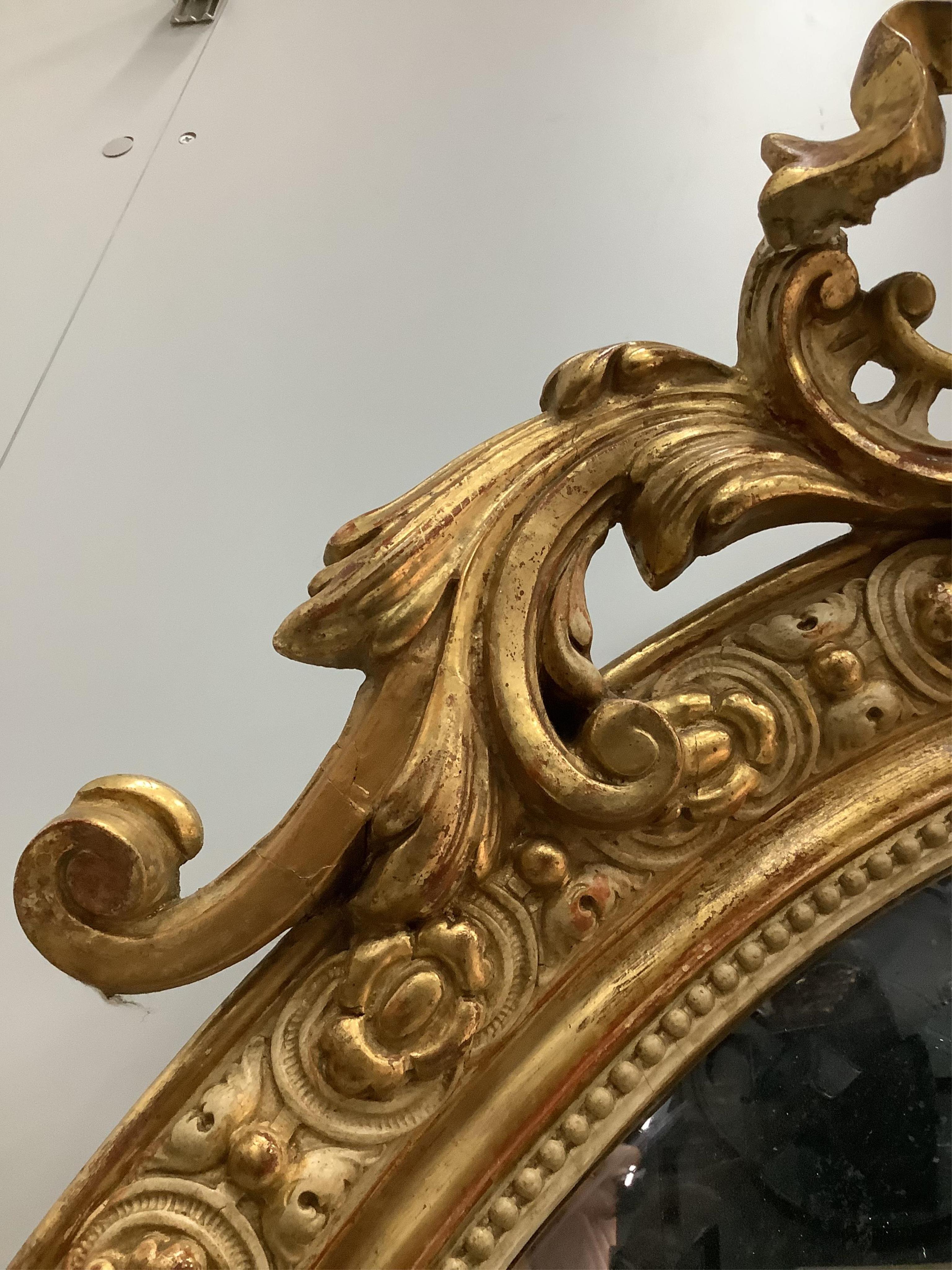 A 19th century French giltwood and gesso wall mirror, width 73cm, height 112cm. Condition - fair, some small losses to the upper crest